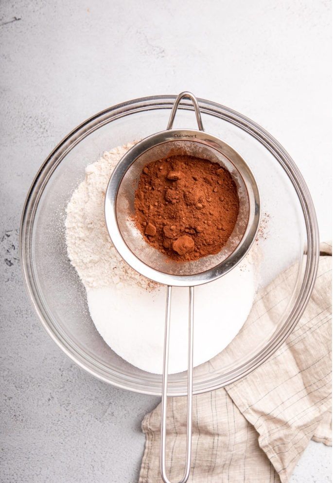 cocoa-powder-in-metal-sieve-added-to-dry-ingredients-1-of-1-683×1024