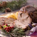 Redondo de ternera asado presentado en bandeja con fondo navideño