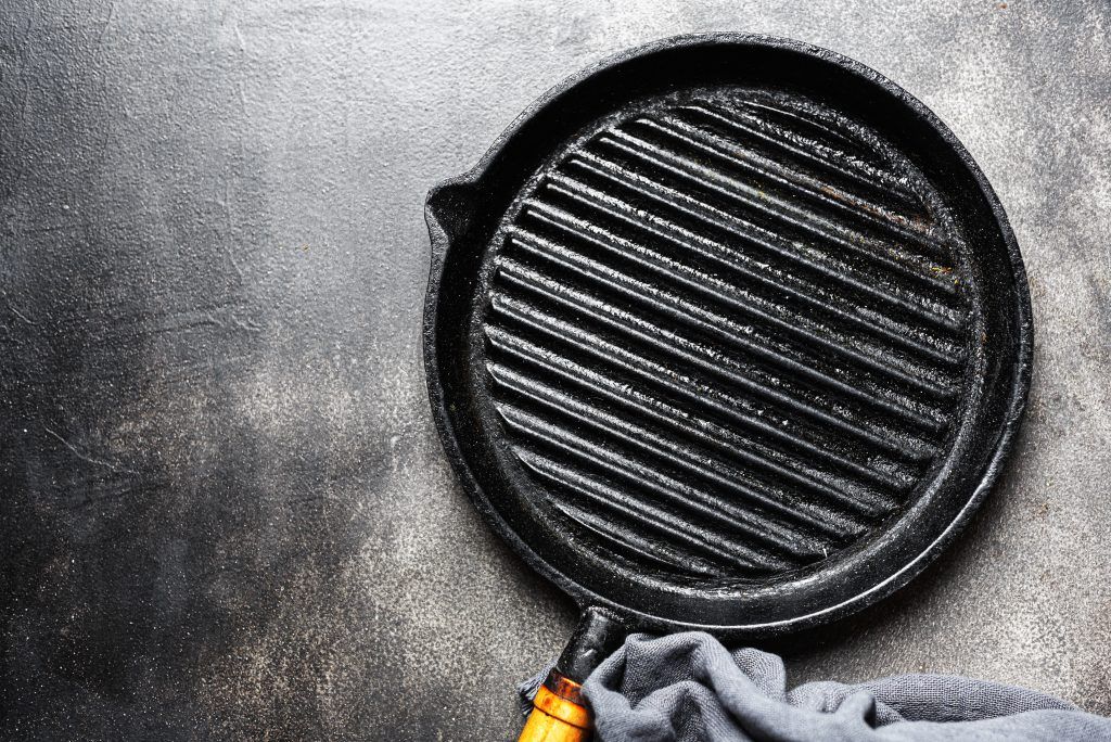 Empty iron grill pan on table