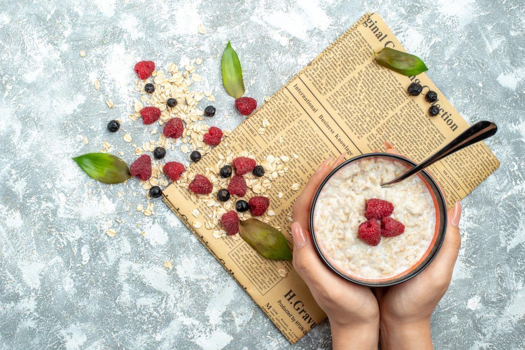 vista-superior-deliciosas-gachas-avena-frambuesas-fondo-claro